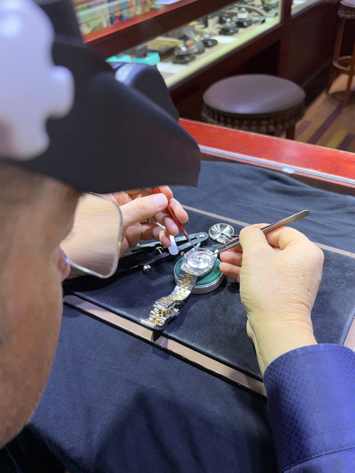 Konstantin Kupfer working on a watch movement under magnification.